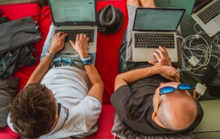 two men working on laptops